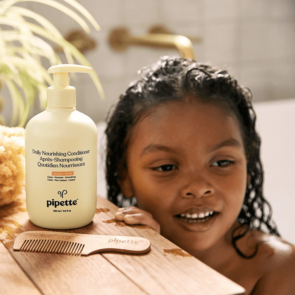 Kiddo in bath using Pipette Daily Nourishing Conditioner