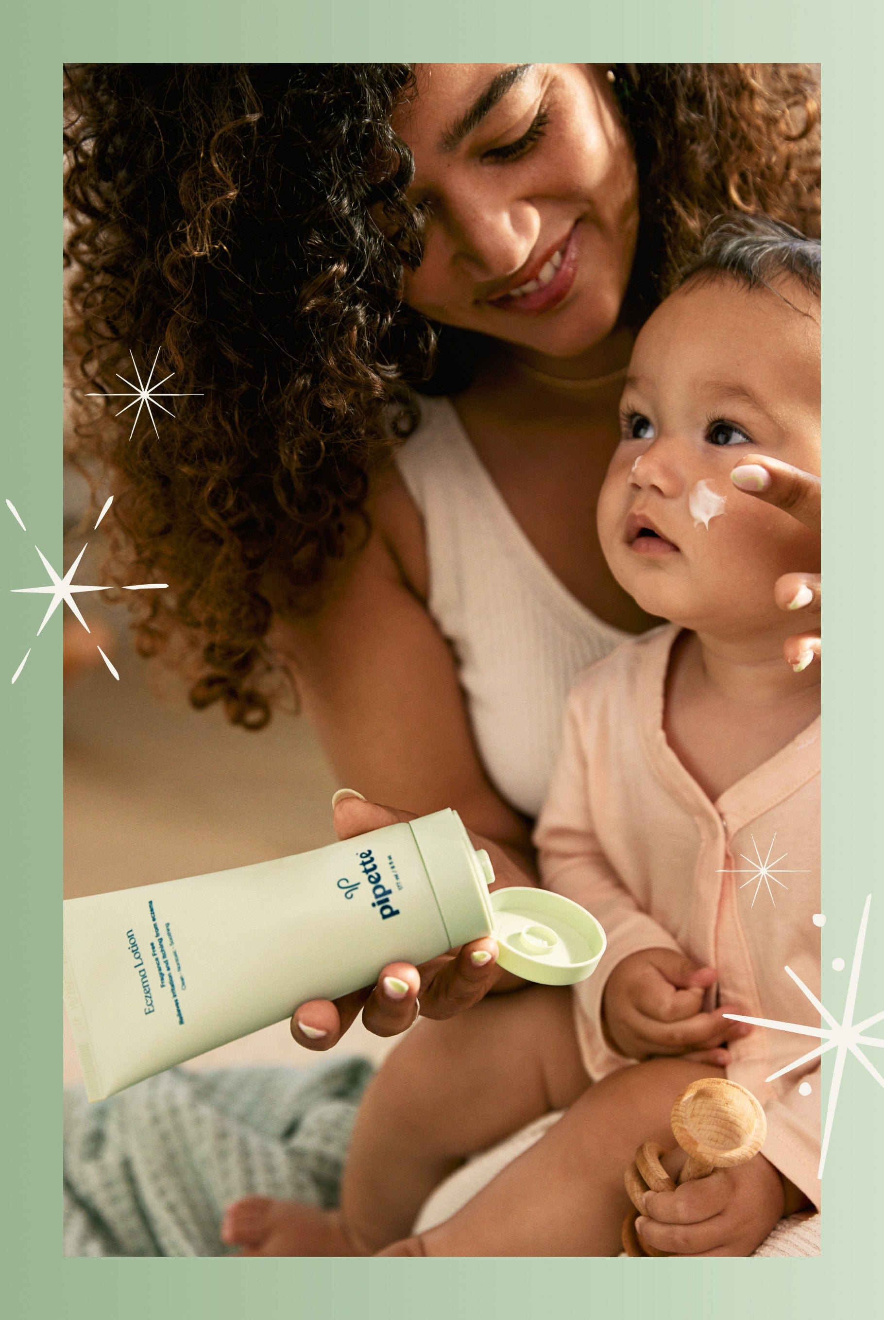 Mom putting lotion on baby