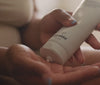 Mom applying lotion to her body