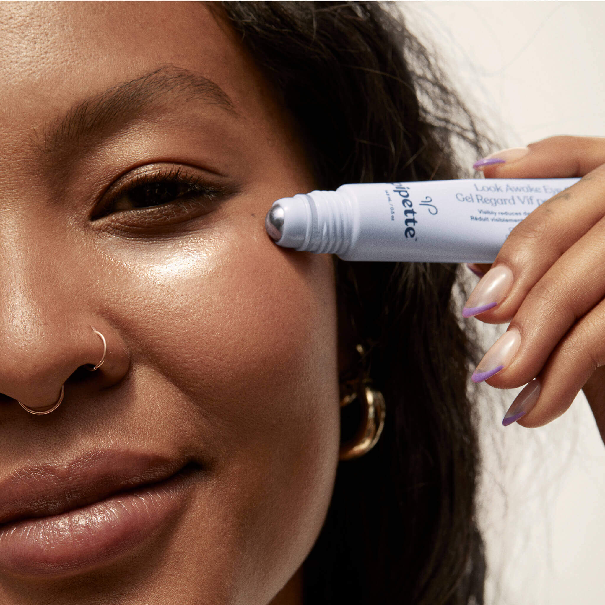 mother using look awake eye gel product on her eye