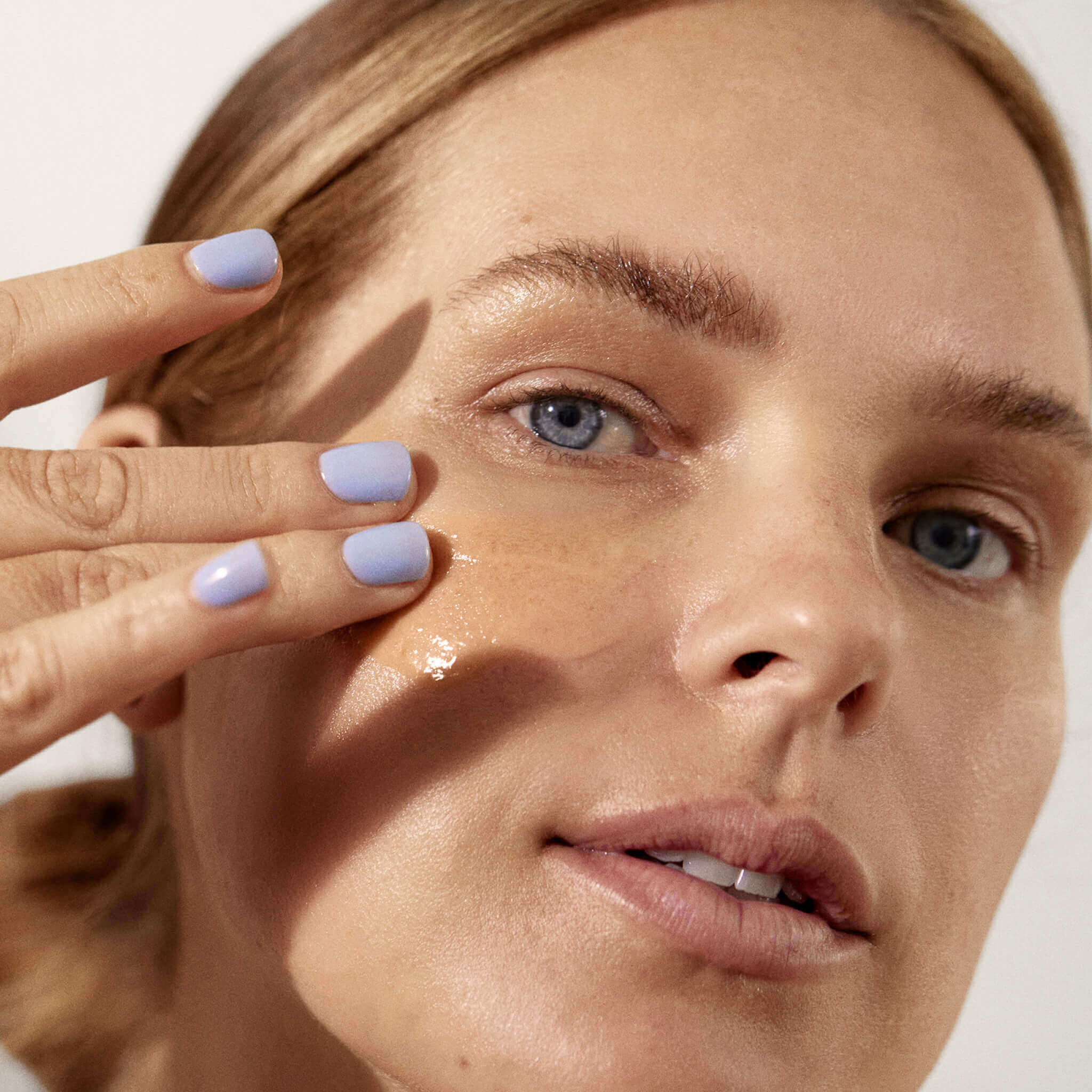 woman using brightening mask on her face that combat dullness, address discoloration, and boost skin’s natural exfoliation process