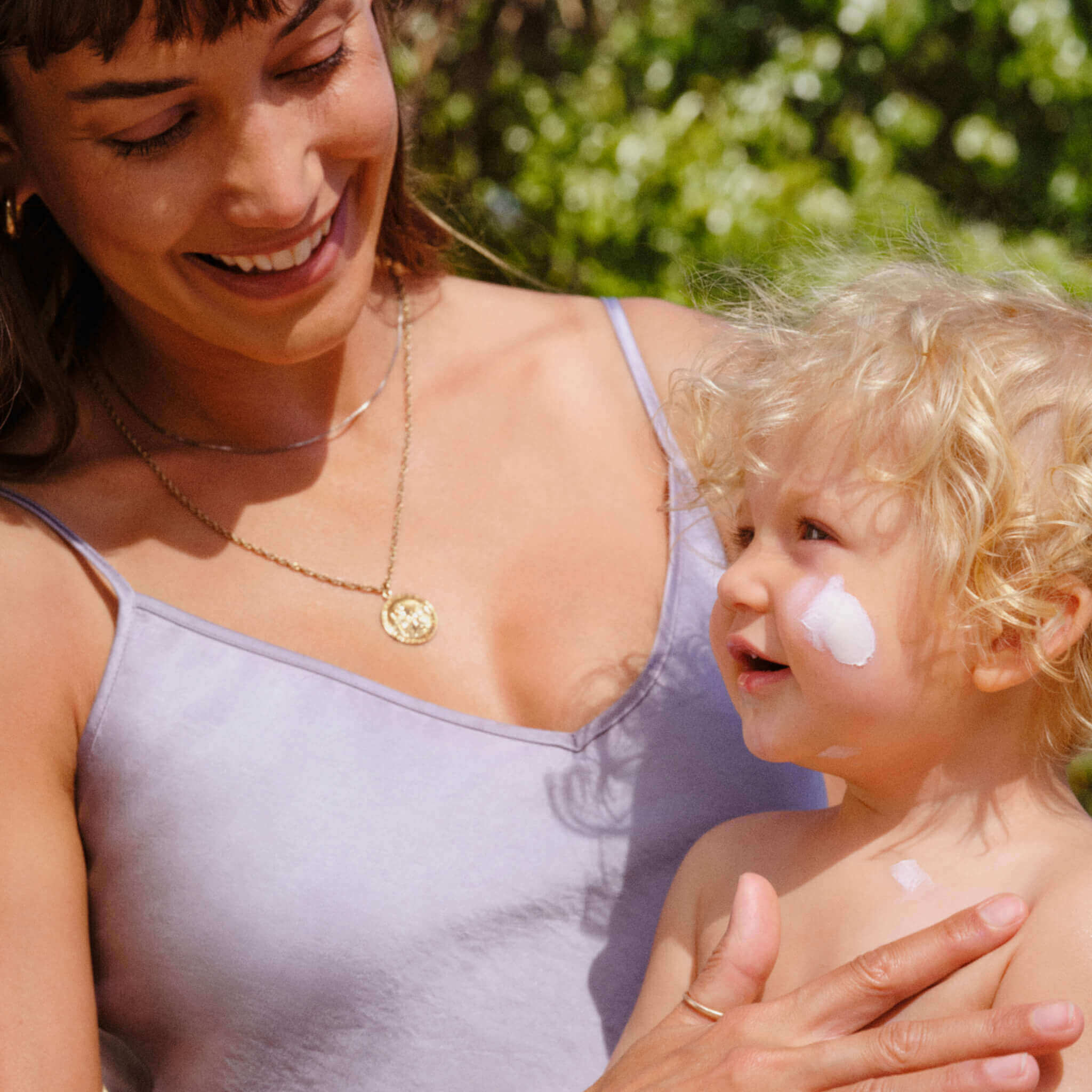 mother applying mineral sunscreen on her child