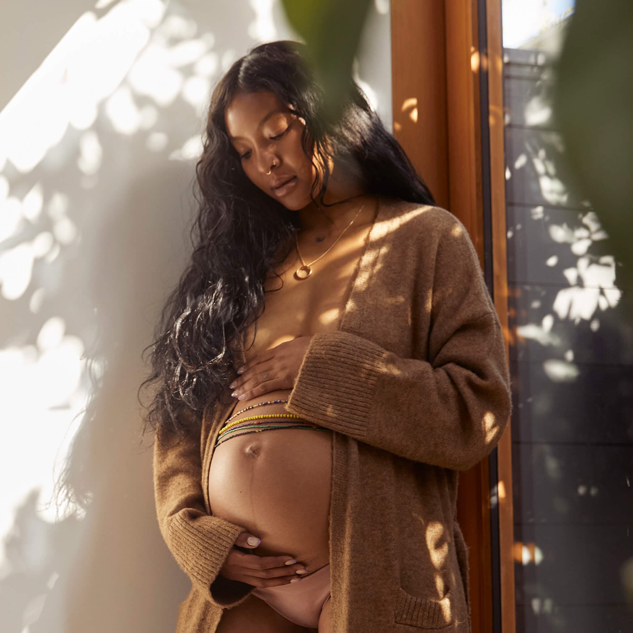 pregnant woman holding her belly
