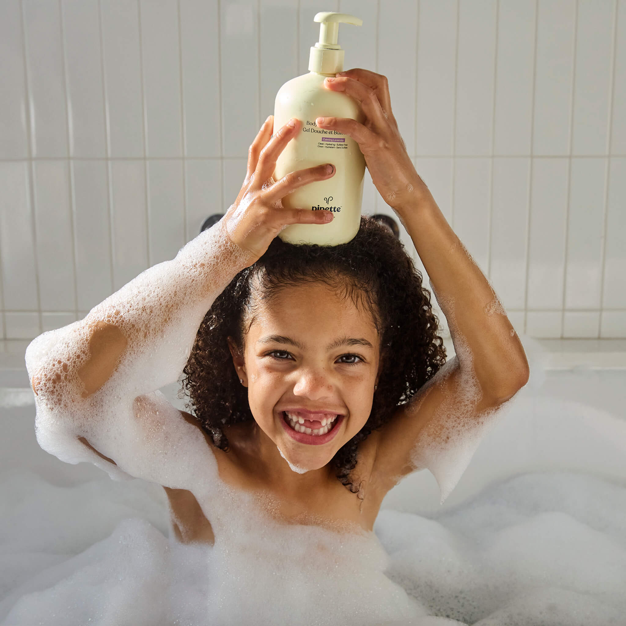 girl in shower using with bottle of body wash and bubble bath by pipette baby