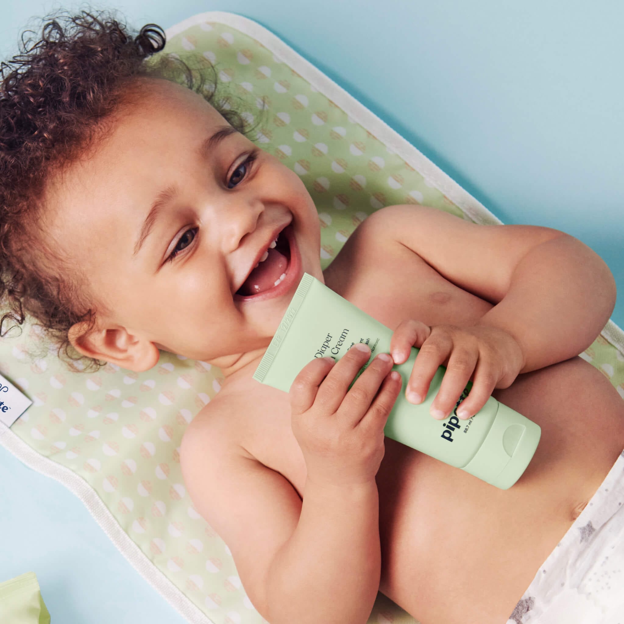 baby on a diaper changing pad 