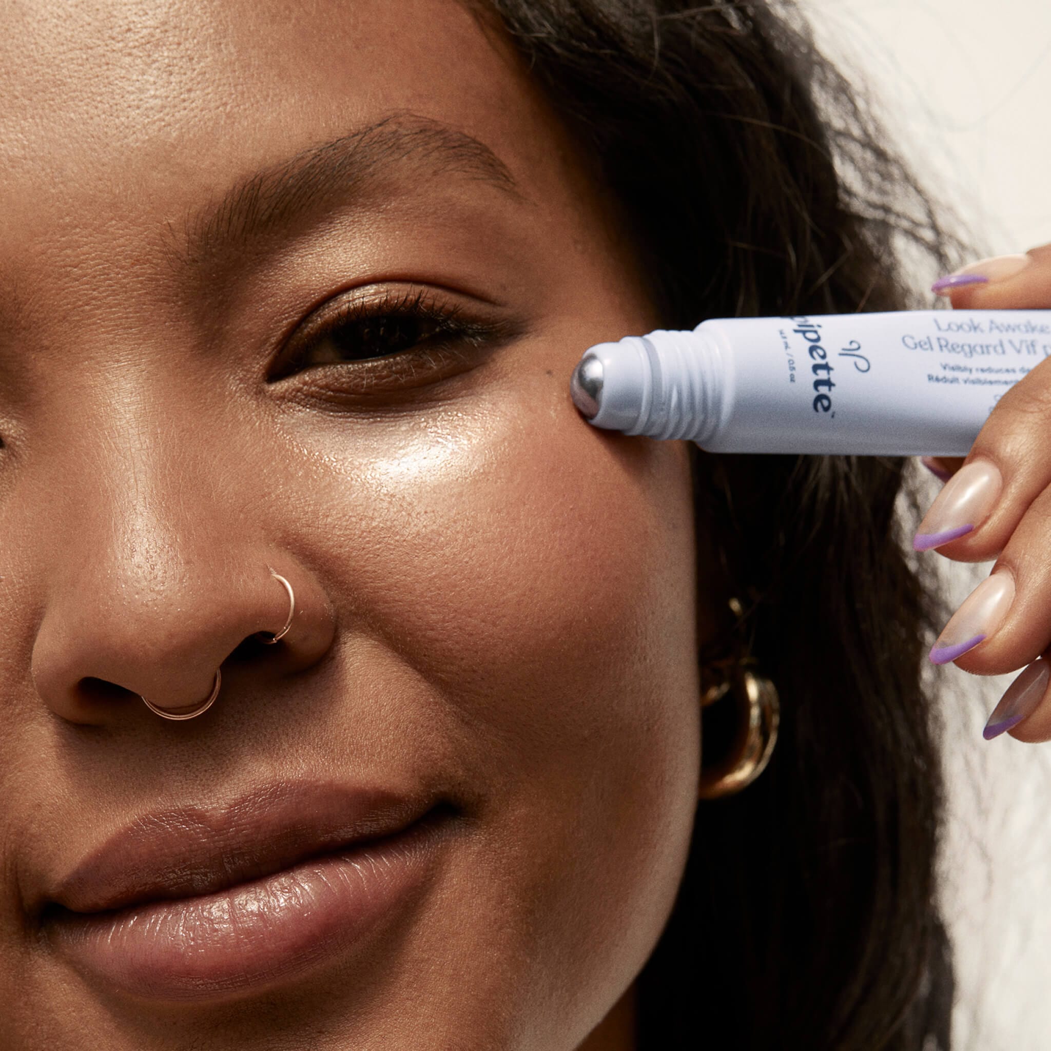 woman applying eye gel under her eye